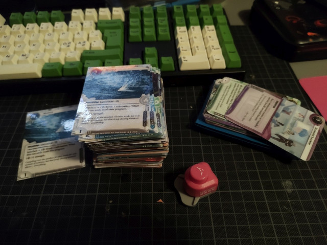 a deck of laminated playing cards from the game Netrunner. 