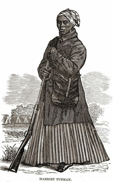 A woodcut of Tubman in her Civil War clothing, with pleated skirt, holding a rifle. By woodcut artist not listed; W.J. Moses, printer; stereotyped by Dennis Bro&#039;s &amp; Co. - Scenes in the Life of Harriet Tubman by Sarah H Bradford, Public Domain, https://commons.wikimedia.org/w/index.php?curid=3078699