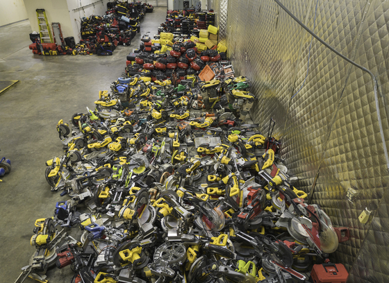 Photo of an immense number of stolen power tools in some kind of warehouse