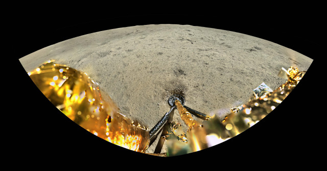 A wide angle shot with the lander leg in the front and the moon in the distance