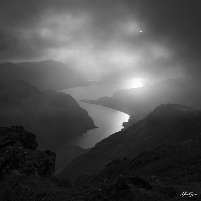 black and white misty loch view from a mountain summit