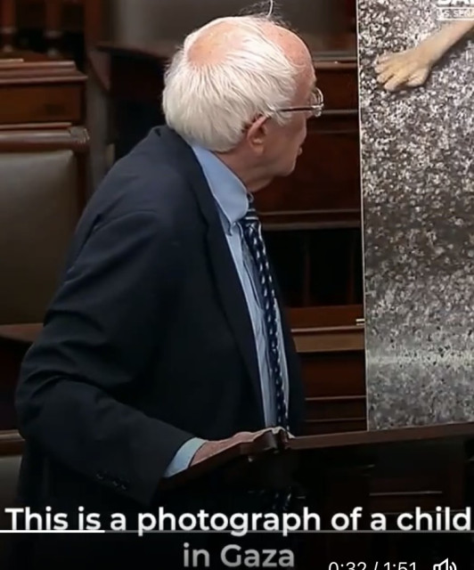 bernie sanders showing a photo of a starving child in gaza