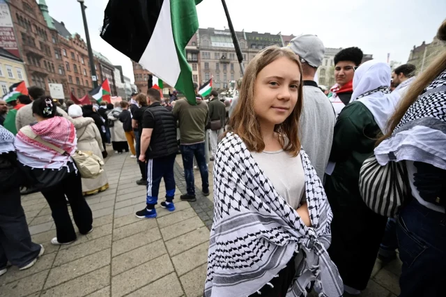 Photo of Greta Thunberg with a Keffiyeh round her shoulders at a Palestine protest outside Eurovision, people with Palestine flags in the background. From this website: 

https://www.freemalaysiatoday.com/category/leisure/2024/05/09/greta-thunberg-joins-pro-palestinian-protest-ahead-of-eurovision-semi/