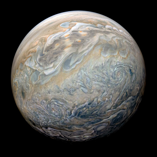 Image of Jupiter, full of swirling storms and bands.