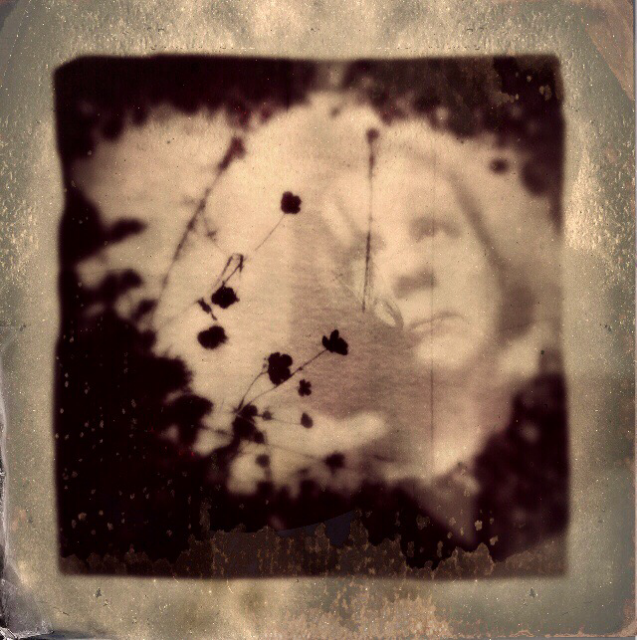 Self portrait, shadows of flowers in a puddle. Polaroid emulsion lift and multilayer photography.
