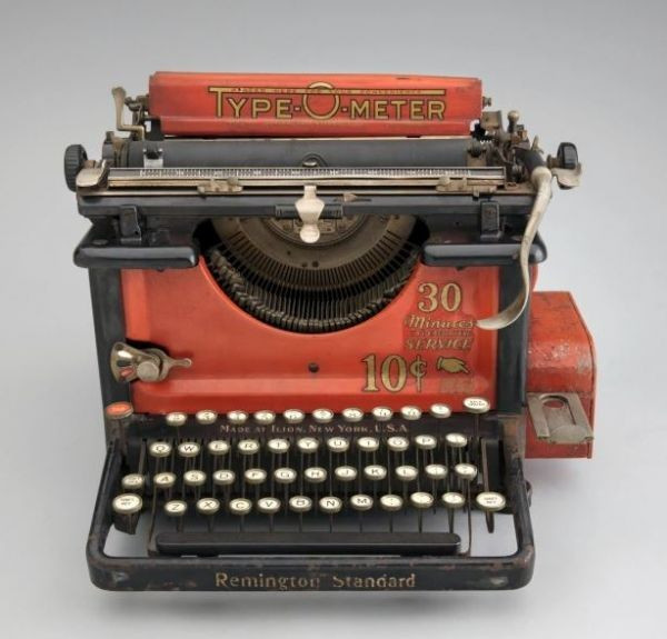 an old Remington Standard typewriter, painted red, called a type-o-meter: 10 cents got you 30 minutes of typing time