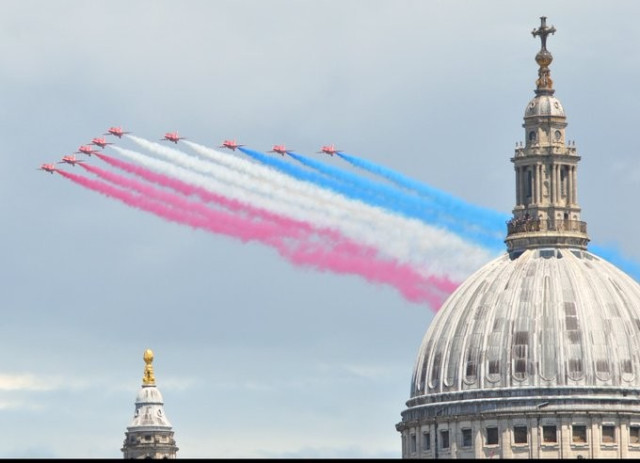 The Red Arrows trailing smoke which resembles the trans pride colours.