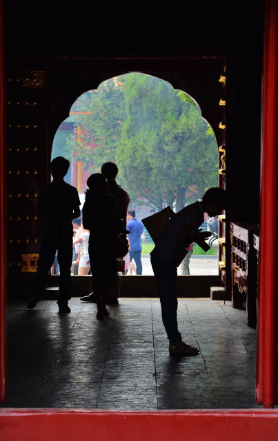 praying in Lama Temple Beijing China