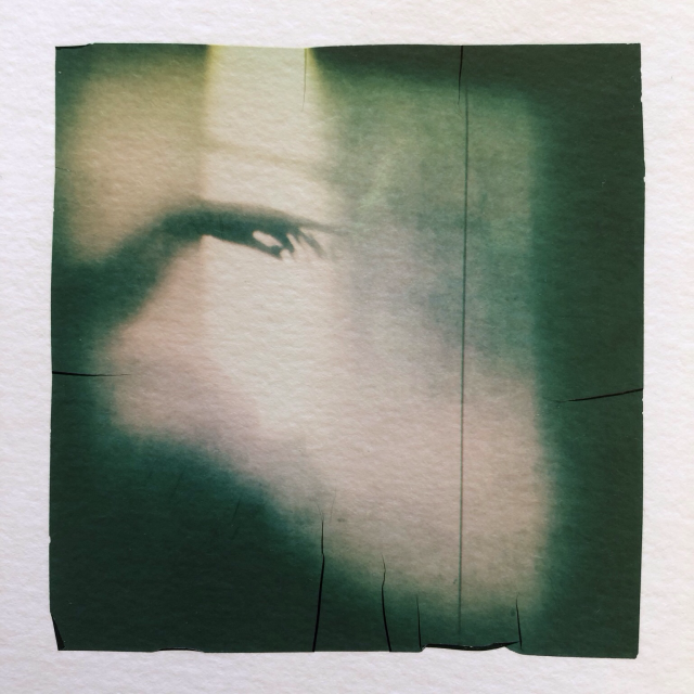 A hand with the forefinger seeking for contact. Polaroid emulsion lift.