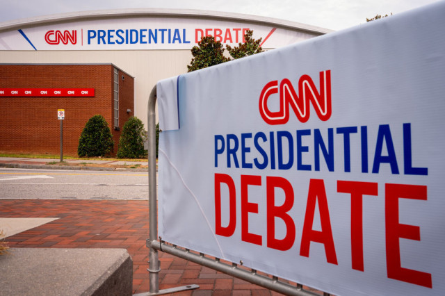 Photo of a large building with a sign reading CNN Presidential Debate, also a sign on the walkway