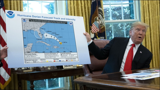 Trump in the oval office with NOAA hurricane map.  Trump extended the hurricane's path with a Sharpie because NOAA contradicted him.