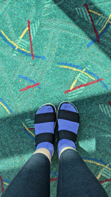 Portland carpet with Helen's feet in black sandals with purple socks