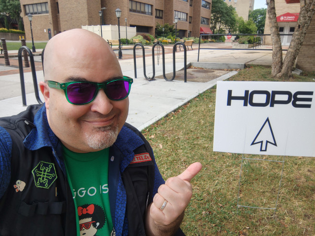 Selfie of the undersigned posing with a sign directing HOPE attendees to the conference.