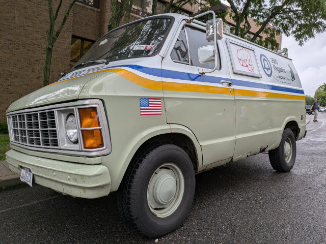An old van painted to look like an AT&T vehicle with 2600 iconography 