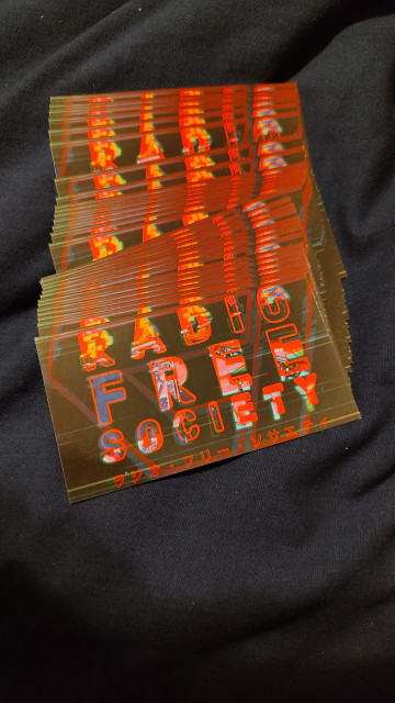 A small pile of very preem Radio Free Society stickers