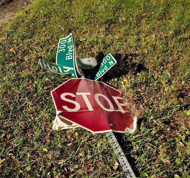 Accident or vandalism? I'm not certain.  This has become a very frequent sight around Jacksonville.  Stop signs and other traffic signs damaged and lying flat on the ground.
