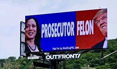Picture of billboard with a picture of Kamala Harris and the word 'Prosecuter' on one side and Donald Trump and the word 'Felon' on the other side.