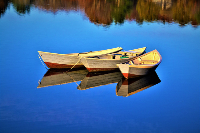 The Three Dories

The Three Dories, Kennebunkport, Maine.
Picture taken in late Autumn on a quite still morning. It was the last day of October 2022, and I was treated to what I might say was the most amazing sunrise I have witnessed at Parsons Beach in Kennebunk, Maine. The thrill of that sunrise fueled me to venture more and by doing so, I grabbed a few more nice captures.