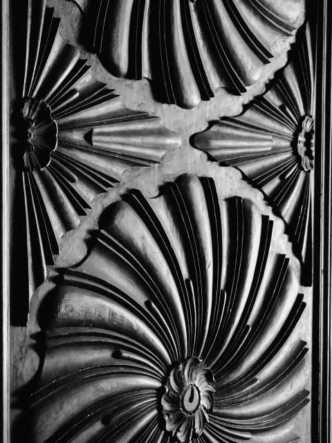 Swirling carved patterns on a wooden door at Málaga's beautiful cathedral