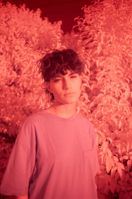 a portrait of Costanza in infrared near a plant