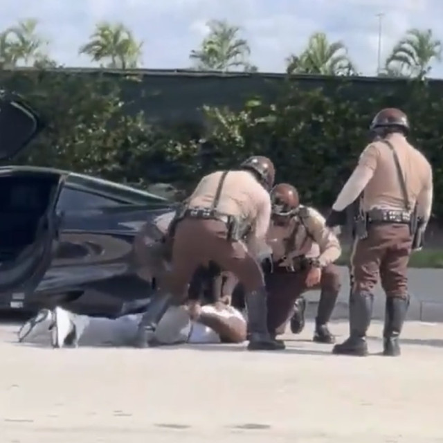 NFL wide receiver Tyreek Hill being put down face first by 3 uniformed officers hours before his game. 