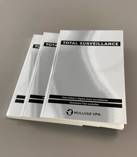 A photograph of three silver books, entitled Total Surveillance.