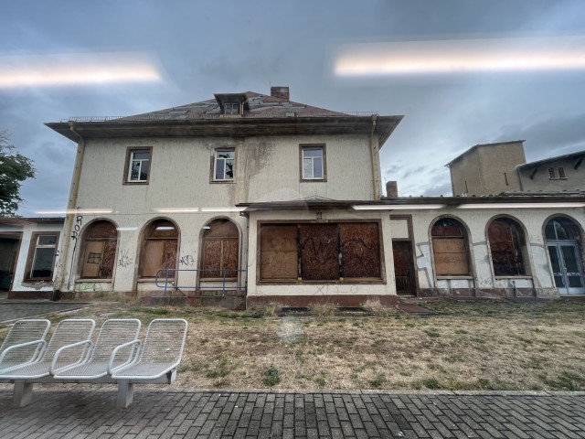 Derelict Bad Köstritz station building. Ground floor windows boarded up. First floor windows broken 