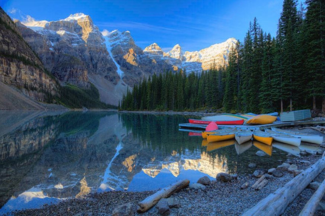 Moraine Lake Sunrise Blue Skies Canoes - Banff National Park Alberta Canada

Moraine Lake, nestled in the Valley of the Ten Peaks in Banff National Park, Alberta, is a dream destination for travel photographers. Its striking turquoise-blue waters, framed by rugged, snow-capped mountains, offer a perfect subject for both landscape and adventure photography. The color of the lake changes with the seasons due to glacial melt, creating an ethereal palette that’s especially vibrant during the summer.

Photographers will find numerous vantage points, including the iconic Rockpile Trail, which provides a panoramic view of the lake and surrounding peaks. Early mornings are ideal for capturing the calm reflections of the mountains in the glass-like water, while golden hour casts dramatic light across the landscape. Wildlife, such as bears, elk, and birds, add a dynamic element to the environment, making it rich for storytelling.

https://fineartamerica.com/featured/moraine-lake-sunrise-blue-skies-canoes-wayne-moran.html

#MoraineLake #Sunrise #Banff #Alberta #Canada #Mountains #Lake #Hiking #nature  #travel #travelphotography #landscapephotography

#AYearForArt #buyintoArt #fineart #art #FillThatEmptyWall #homedecorideas 
