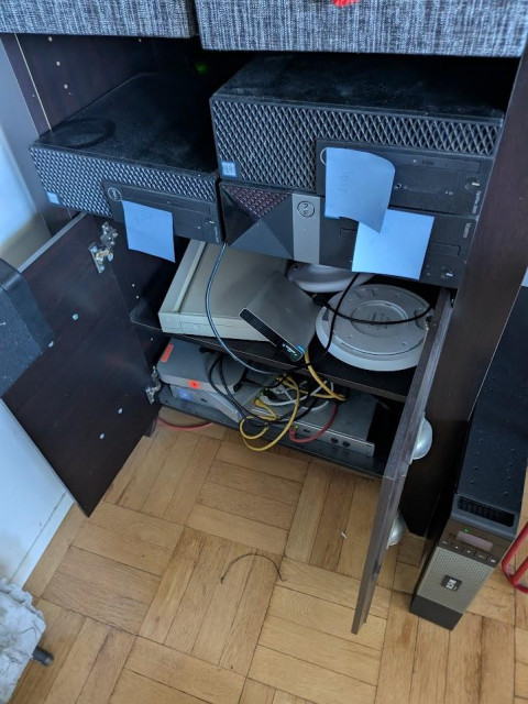 a wayfair shelf with a bunch of computer crap in it