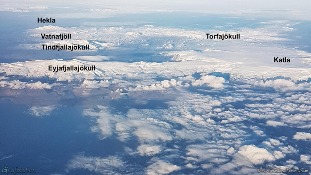 The same photo of a landscape from a plane, but this one has the names superimposed over the peaks.