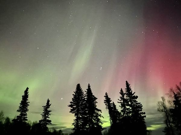 Northern Lights streaming in green and red.