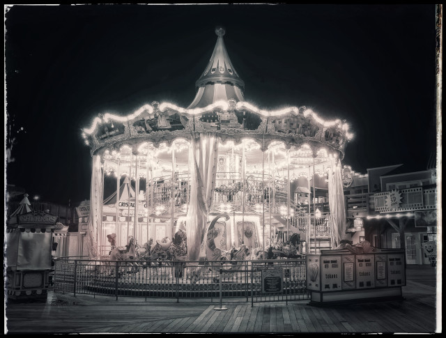 A 4 second night-time photo of the carousel on Pier 39. Tinted slightly red, but largely monochrome, this two-story beast of faux victoriana and carnival excess glows like a radioactive pile just before its critical mass blows it out of existence. 

Hot.