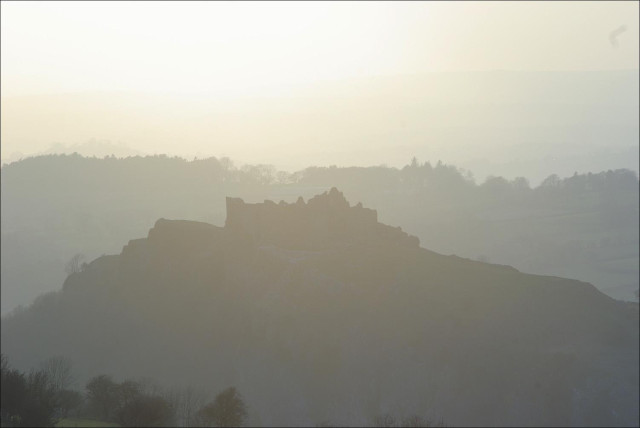 Carreg Cennen castle against the late afternoon sun, Wales, 2010.