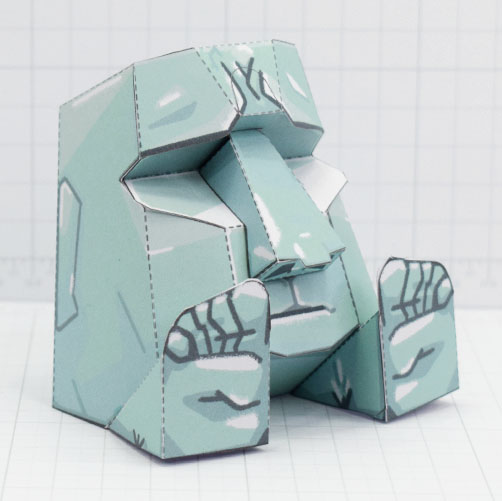 a photo of a papercraft depicting a moai head with feed attached 