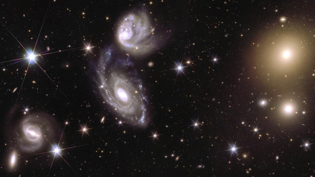 This image shows an area of the mosaic released by ESA’s Euclid space telescope on 15 October 2024. The area is zoomed in 150 times compared to the large mosaic. On the left of the image, Euclid captured two galaxies (called ESO 364-G035 and G036) that are interacting with each other, 420 million light-years from us. On the right of the image, galaxy cluster Abell 3381 is visible, 678 million light-years away from us.