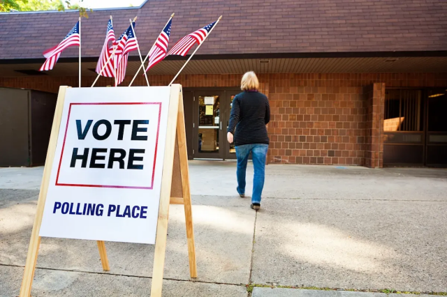 A woman entering a polling place: