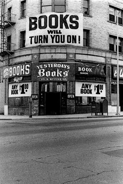 A black and white photo of a book store called "Yesterday's Books" with "Any Book $1.00"

On the first floor, is a big sign "BOOKS will turn you on!"