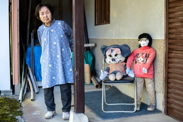 Hisayo Yamazaki standing next to the puppets outside her house in Ichinono

Photograph: Philip Fong/AFP/Getty Images