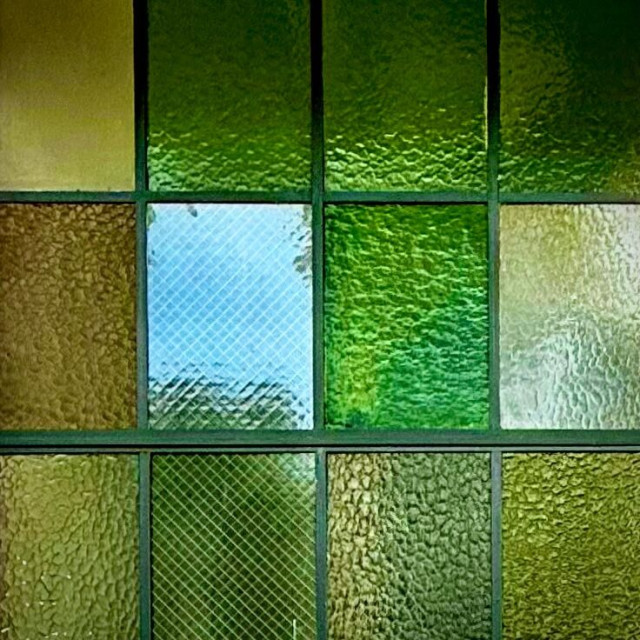 Industrial window panes with glass in varying textures and shades of green