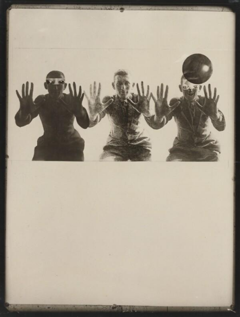 Three repeated figures with their hands up facing the viewer, the third one's head partially obscured by a spherical translucent object