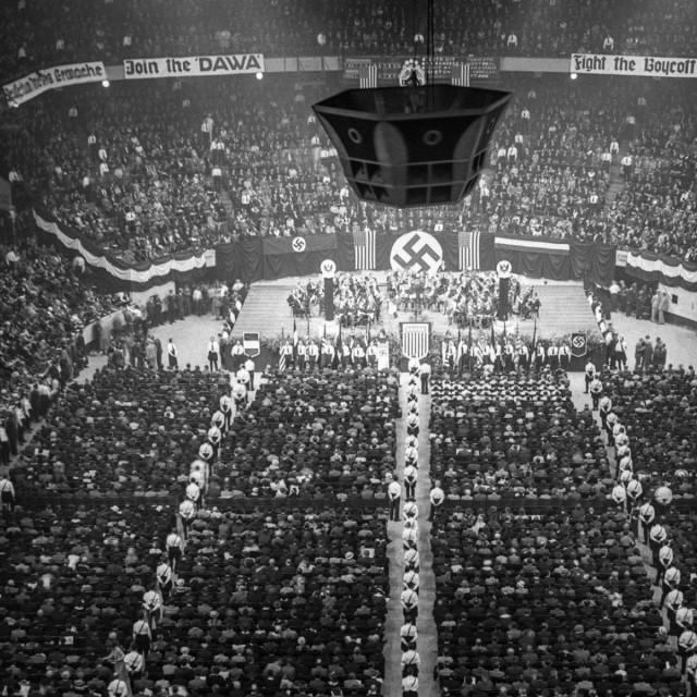 On February 20, 1939, the German American Bund organized a Nazi rally at Madison Square Garden that drew over 20,000 attendees. The rally was billed as a pro-"Americanism" event, and featured a large portrait of George Washington with swastikas on either side. Around 100,000 anti-Nazi counter-protesters gathered outside the venue. 
 The rally was billed as a pro-"Americanism" event, and featured a large portrait of George Washington with swastikas on either side.