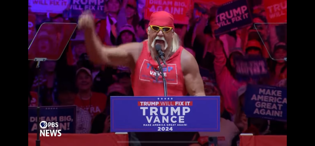 Hulk Hogan at Trump/Vance rally in front of by audience holding Trump signs.