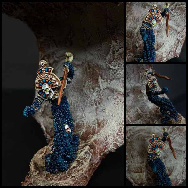 A collage of photos of a painted miniature, Prince Apophas, a tomb kings prince miniature from Games Workshop. The miniature is a skeletal figure rising out of a body of scarabs, it has ornate bejewelled armour of blue and red. It is holding a dagger over head and is reaching out with a hand made of scarabs. 