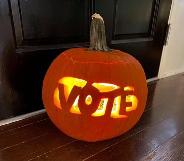 A pumpkin I carved that says VOTE”