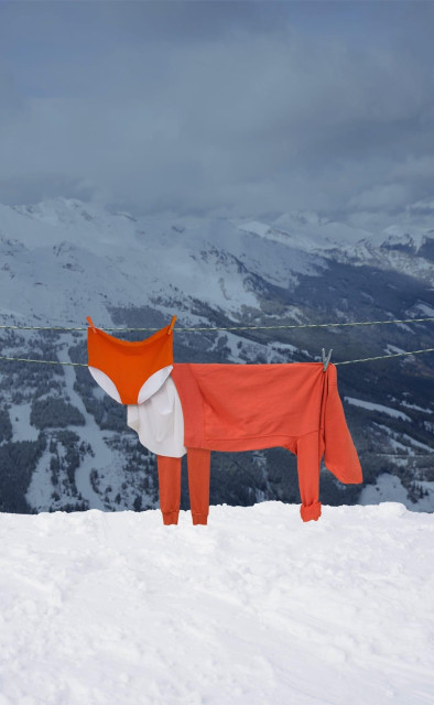 orange and white garments draped over a clothesline to look like a fox