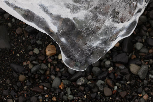 A block of ice melts at Diamond Beach, near Jokulsarlon, a glacier lagoon in southern Iceland, August 2024. REUTERS/Stoyan Nenov