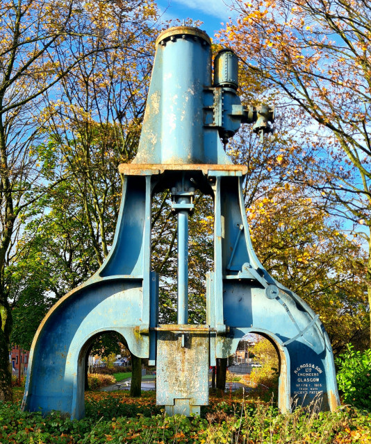 A large steam hammer dating from 1915 which has been erected at a road junction in the east end of Glasgow.