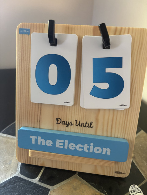 A wooden countdown calendar displays "05 Days Until The Election.