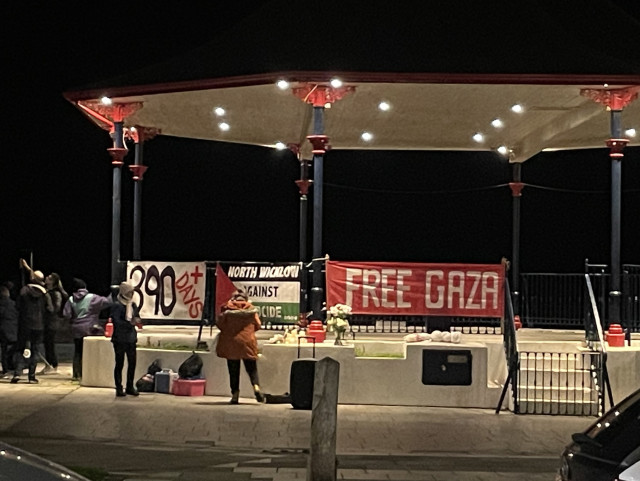 Photo of Bray bandstand with protest posters: Free Gaza. North Wicklow against genocide. And a Palestinian flag.