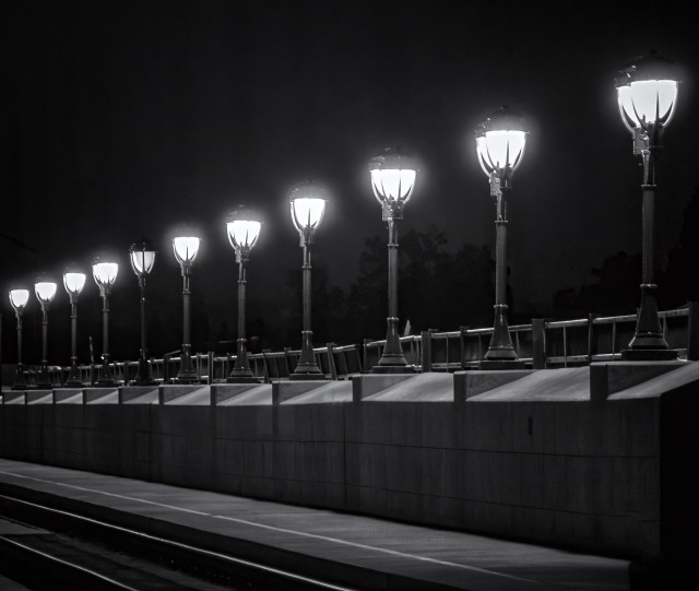 Row of street lights at night along a causeway in Napa, CA.